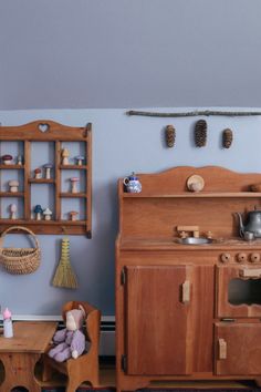 an old fashioned wooden toy kitchen in a playroom