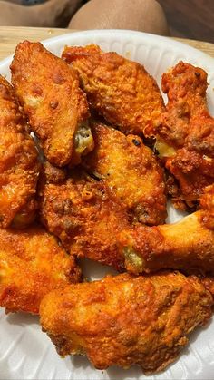 fried chicken wings on a paper plate ready to be eaten