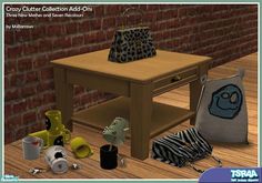 an animal print purse sitting on top of a wooden table next to other items in front of a brick wall