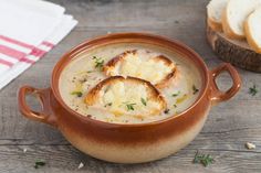 a bowl of soup with bread on the side