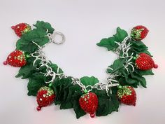 I love  strawberries This just screams Summer to me. These strawberry charms are heavier,  so that will make the bracelet heavier.  Made with bling charms, acrylic charms, and silver tone materials.  I have  matching earrings listed too. Be sure to check out my other items too. I have amazing deals in my CLEARANCE EARRINGS section! Check them out. Fun Silver Metal Jewelry, Fun Nickel-free Metal Jewelry, Novelty Red Resin Jewelry, Red Resin Novelty Jewelry, Novelty Dangle Charms Jewelry, Christmas Novelty Silver Jewelry, Novelty Dangle Jewelry With Charms, Novelty Jewelry With Dangling Charms, Whimsical Silver Resin Jewelry