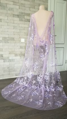 a mannequin wearing a purple dress with flowers on it