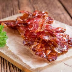 bacon and lettuce on a wooden cutting board