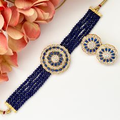 "American diamond cz kundan necklace choker set.  This kundan set features a geometric shape in a gorgeous blue, mint or pink color scheme adding a touch of modern elegance.  You'll definitely stand out wearing this beauty!  Set includes: necklace and earrings Earrings L: 1\" | W: 1\" Items are carefully packed and ready for gifting. All pictures are taken in natural light please allow for slight variations in color due to camera settings. Jewelry Care ✨Protect your jewelry in a closed box or po Blue Temple Jewelry With Round Shape, Blue Kundan Jewelry With Meenakari, Blue Hand Set Necklace For Diwali, Elegant Blue Jewelry Sets For Diwali, Blue Round Meenakari Jewelry, Blue Bollywood Necklace For Receptions, Blue Kundan Jewelry For Diwali, Blue Kundan Necklace For Diwali Celebration, Blue Choker Jewelry For Festive Occasions