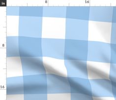 a blue and white checkered fabric is shown in close up view with the ruler