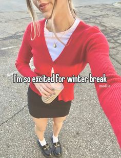 a woman in a red sweater and black skirt is standing on the street with her hands behind her back