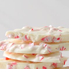 white and red candy canes stacked on top of each other in front of a white background