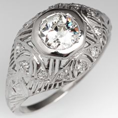 an antique style diamond ring with filigrees