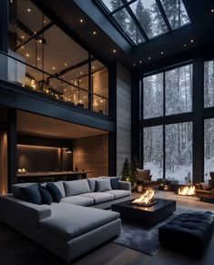 a living room filled with lots of furniture next to a fire place in front of large windows