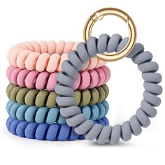 a stack of multicolored rings with a gold ring