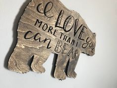 a metal bear with the words love more than you can bear on it's back