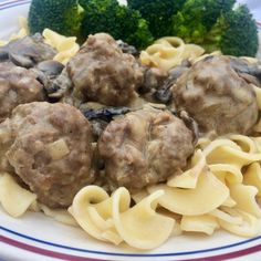 some meatballs and noodles on a plate with broccoli