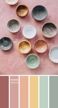 there are many bowls on the table with color swatches in each one, including pink and green