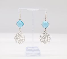 Dangling from delicate silver filigree work, these earrings feature a light blue stone that adds a soft and refreshing touch of color, while the intricate metalwork lends an air of sophistication and intricacy to create a truly enchanting accessory. The combination of the light blue stone and the detailed filigree design results in earrings that effortlessly blend grace and craftsmanship. Delicate Blue Topaz Jewelry, Light Blue Metal Earrings As A Gift, Light Blue Metal Earrings For Gift, Light Blue Blue Topaz Drop Earrings, Light Blue Topaz Drop Earrings, Blue Sterling Silver Earrings With Intricate Design, Sterling Silver Blue Earrings With Intricate Design, Elegant Light Blue Sterling Silver Earrings, Blue Intricate Design Drop Earrings