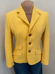 Stunning Ralph Lauren wool three leather button closure, fully lined blazer jacket in sunflower yellow. Beautifully detailed with faux front pockets and leather elbow patches and braided leather buttons. Perfect for autumn and spring wear.  This is in excellent condition and tagged a size 8. See laying flat measurements  Shoulder:17" Bust:38" Waist:34" Length:23" Sleeve:22" Leather Elbow Patches, Sunflower Yellow, Spring Wear, Vintage Ralph Lauren, Elbow Patches, Ralph Lauren Polo, Braided Leather, Wool Blazer, Saddle