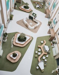 an aerial view of a courtyard with seating and plants