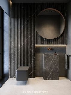 a modern bathroom with black and white marble wallpaper, round mirror above the sink