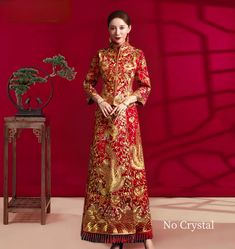 Indulge in the opulent elegance of this 2-piece qun kwa set, embellished with luxurious gold and silver embroidery. The exquisite detailing of dragons, phoenixes, flowers, and lucky clouds graces both the jacket and skirt, while shimmering crystals provide a dazzling touch for an unforgettable ensemble at your tea ceremony. Please note Asian size run small, refer to the size chart in the picture. Please leave Height, Weight and Bust measurements in the Personalisation box so you can double check the size for you Festive Gown With Gold Embroidery For Traditional Ceremonies, Gold Long Sleeve Gown With Zari Work, Elegant Brocade Dresses With Zari Work, Gold Zari Work Long Sleeve Gown, Traditional Gold Gown For Ceremonial Occasions, Festive Ceremonial Gold Gown, Brocade Dress For Wedding And Festivals, Brocade Wedding Dress For Festivals, Floor-length Gown With Gold Embroidery For Traditional Ceremonies