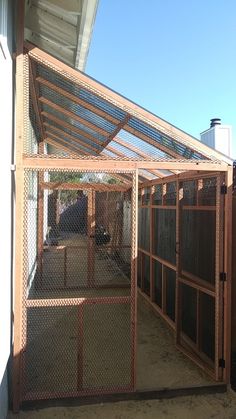 an outdoor area with a fence and some animals in it