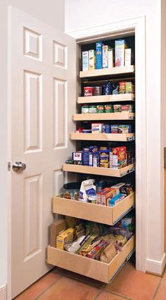 an organized pantry in a kitchen with lots of food on the shelves and under the door