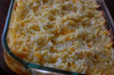 a casserole dish filled with macaroni and cheese on a wooden table