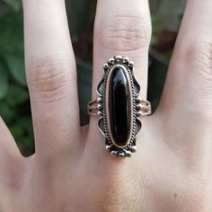 "This is a gorgeous Black Onyx and Sterling Silver Ring that has a long oval shaped Black Onyx cabochon. The raised Onyx cabochon has been set in an ornate Sterling Silver bezel that is slightly rounded on the back making it super comfortable sitting against the finger. The rounding at the back of the bezel allows for the ring to fit perfectly against the shape of your finger. The ring has been slightly oxidized to show the details in the setting and then polished to a high sheen to bring out th Black Oval Cabochon Jewelry, Oval Black Cabochon Jewelry, Black Sterling Silver Jewelry With Oval Cabochon, Black Oval Cabochon Sterling Silver Jewelry, Oval Onyx Black Jewelry, Black Onyx Oval Jewelry, Oval Black Onyx Jewelry, Vintage Black Oval Cabochon Jewelry, Oval Onyx Cabochon Ring