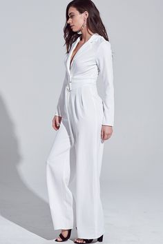 Classic white jumpsuit with a low v-neck and a belt Perfect to wear to a cocktail event. Add any cardigan or wrap to add some print to the outfit. You can also add any color jewelry, heels, or clutch to add a pop of color. This jumpsuit is a must have in every ladies closet. It can also be worn to go on date nights! - Model is 5'9" tall, 34B Chest, 25" Waist and 35" Hips and wearing size Small -Color: White -Style No. IBR96581 -100% Polyester Grad Gowns, Cocktail Event, White Jumpsuit, White Style, Classic White, Fashion Games, Date Night, Color Pop, Jumpsuit