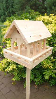 a wooden bird house sitting on top of a tree