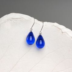 "These Small dark blue teardrop earrings are made of glass in lampwork technique. The earrings hooks are sterling silver and are hypoallergenic. These unique and beautiful earrings are like water drops frozen in glass! They are simple and elegant, very lightweight and comfortable to wear, perfect for everyday wear and for special occasions. 💕 You will definitely receive lots of compliments on your new earrings, everybody loves them, and you'll love them too! Dimensions: total length about 1 1/8 Blue Nickel-free Long Drop Teardrop Earrings, Blue Long Drop Teardrop Earrings With Ear Wire, Nickel Free Blue Teardrop Earrings, Blue Teardrop Drop Earrings, Blue Teardrop Earrings With Ear Wire, Blue Drop Earrings With Ear Wire, Blue Nickel-free Teardrop Earrings, Blue Long Drop Teardrop Earrings Gift, Nickel-free Blue Teardrop Earrings