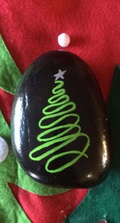 a rock with a christmas tree painted on it