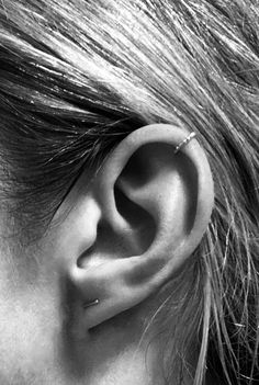 a woman's ear is shown in black and white