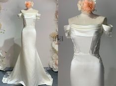 a white wedding dress with an orange flower on the top and bottom, next to a mannequin