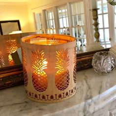 a candle that is sitting on top of a table next to a mirror and other items