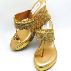 These stunning gold toe ring synthetic leather wedges with gold stones flower design with a braided trim are gorgeous. these beautiful platform heel shoes have embroidered design on the heels and lovely rhinestones design on toe. They offer a nice, sweet look, but enough to be unique and stand out when you wear them. They are comfortable to wear for long periods of time. Pictures don't do justice for these wedges. These offer a heel size of 4 inches. We have a wide variety of shoes to choose from. See our page for more of our collection! We ship out in a timely matter, wrapped in care for a safe secure trip to your location. Thank you for supporting our small business! Shipped from USA. Sizes available US 6,7,8,9,10. Gold Toe Post Wedge Sandals, Gold Platform Sandals With Closed Toe, Gold Closed Toe Platform Sandals, Gold Round Toe Wedding Shoes For Summer, Gold Closed Toe Platform Wedge Sandals, Gold Embellished Toe Post Sandals, Gold Embellished Synthetic Sandals, Summer Gold Embellished Heels, Summer Embellished Gold Heels