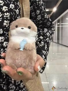 a person holding a stuffed animal in their hands