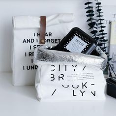 a white bag sitting on top of a table next to some books and other items