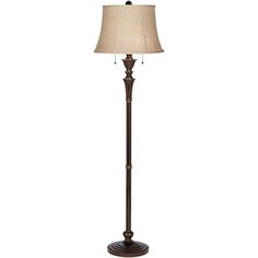 a floor lamp with a beige shade on it