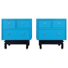 a pair of blue dressers sitting next to each other on top of a white floor