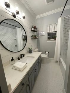 a bathroom with a toilet, sink and shower