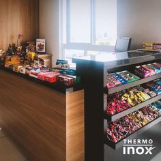 the inside of a candy store with shelves full of candies and chocolates on display