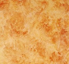 an orange and yellow textured wallpaper with some brown spots on the bottom half