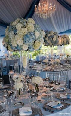 an image of a table set up for a wedding with flowers and place settings on it