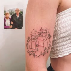 a woman with a tattoo on her arm has an image of two people in the frame