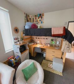 a dorm room with two beds, desk and chair