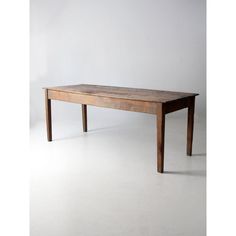 a wooden table sitting on top of a white floor