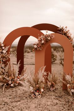 an arch with flowers on it in the desert