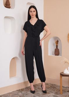 Presenting our Black Oversized Short-Sleeve Jumpsuit--a chic and versatile ensemble. The generously oversized silhouette ensures a relaxed fit, providing both comfort and on-trend appeal. Short sleeves add a touch of casual charm, while the frilled front detail enhances the jumpsuit with a sophisticated and feminine touch. The timeless black hue adds a classic and elegant element, making it a wardrobe essential for various occasions. Whether you're attending a casual day event or a night out, th Womens Jumpsuits, Short Sleeve Jumpsuits, Oversized Silhouette, Black Fits, Unique Fashion, Playsuit Jumpsuit, Jumpsuits For Women, Wardrobe Essentials, Fashion Forward