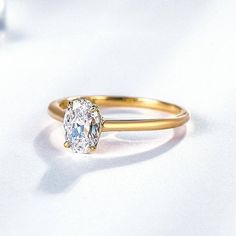 a close up of a diamond ring on a white surface