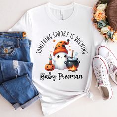 a white shirt that says something spooky is baking baby freeman