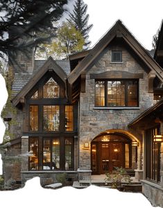 a large stone house with lots of windows on the front and side of it's facade